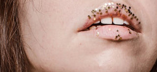 Close up of brown haired girl's lips with sparkles on them