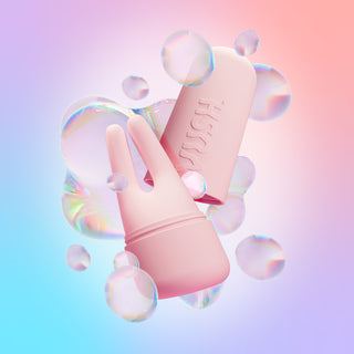 Pink Swish Dual Tip Vibrator and pink case against purple/blue/pink gradient background with digital illustration of iridescent bubbles